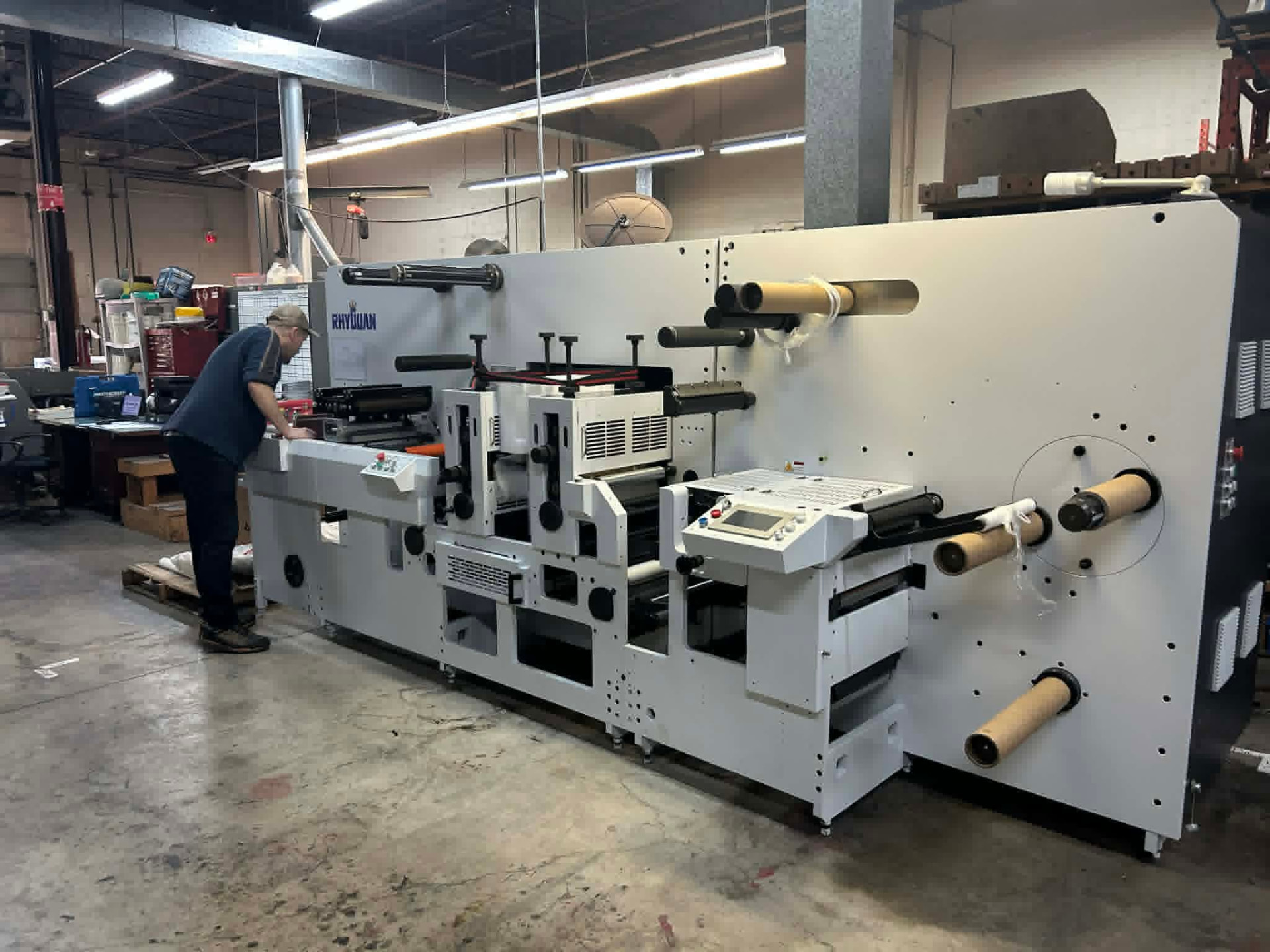 A press operator running a label press at the ICC plant